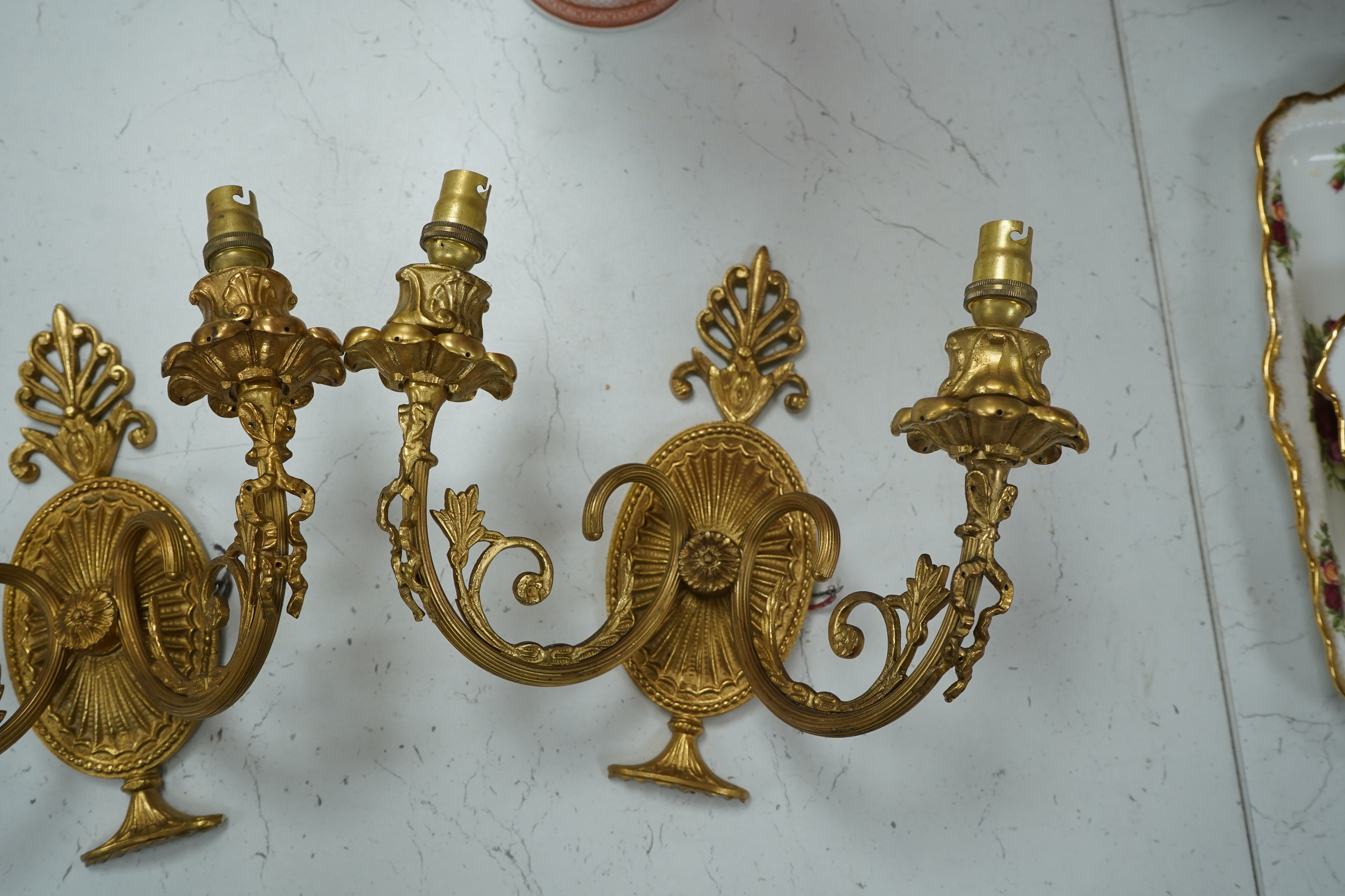 A pair of Adam style gilt brass twin branch wall lights, 23cm long. Condition - good